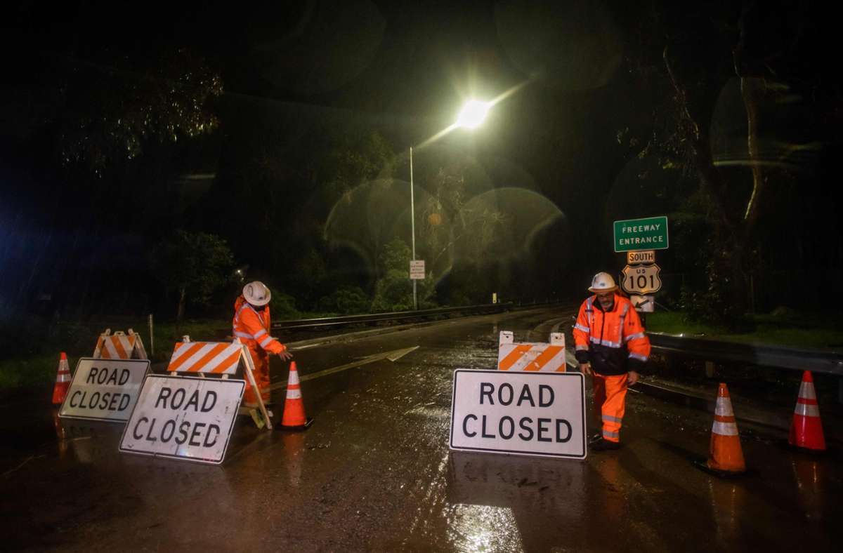 Rettungskräfte sperren in Montecito eine überflutete Straße.